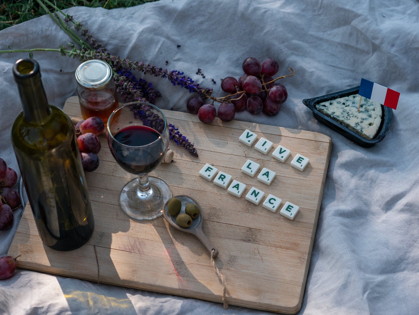 glass of wine on a wooden chopping board